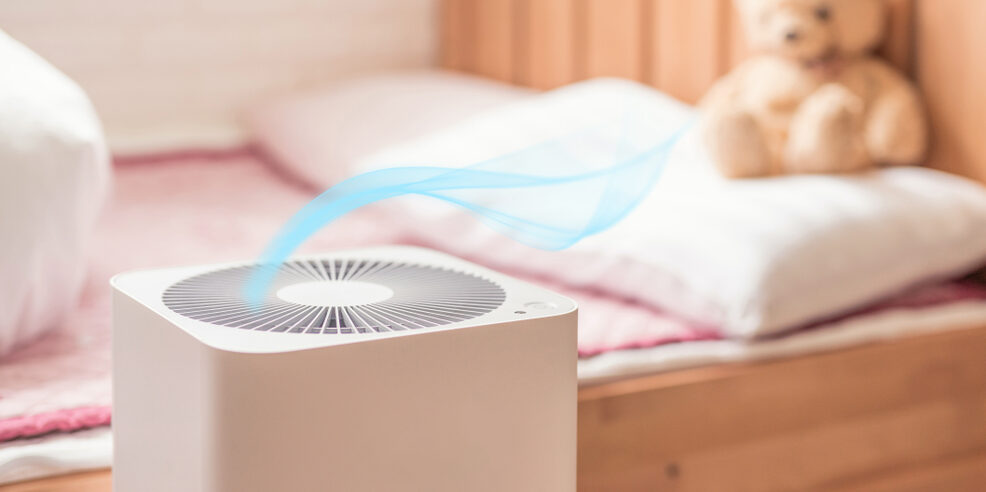 HEPA Air Purifier Cleaning Air next to Bed with Teddy Bear
